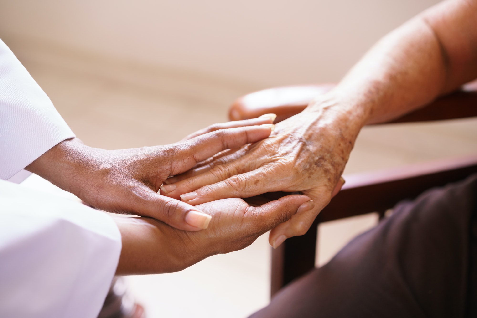 Senior Woman Talking With Black Doctor In Hospice